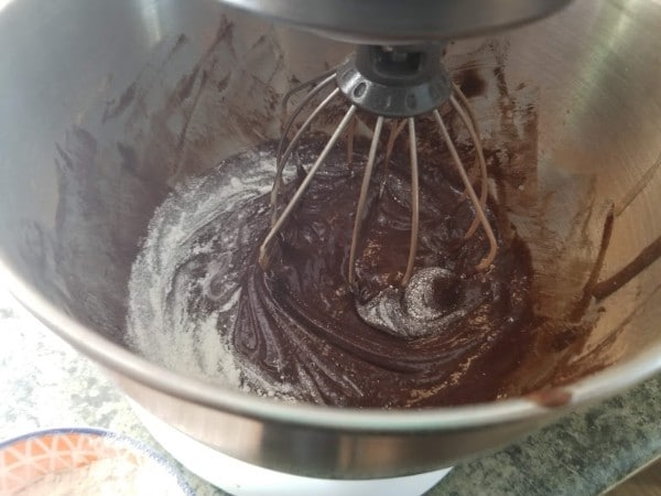 mixing in the flour to the brownie batter