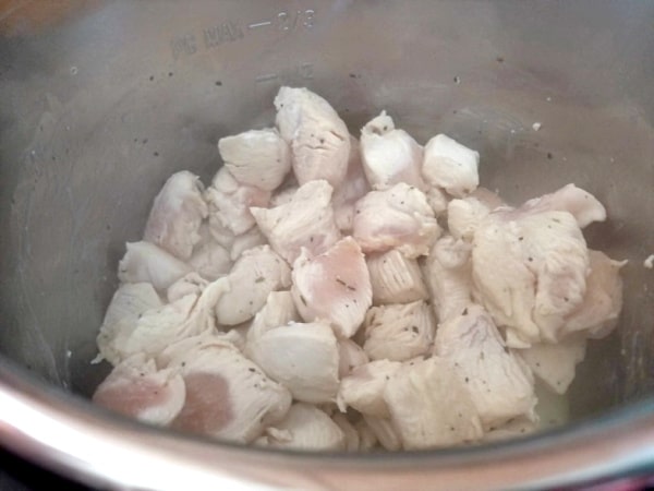browned cubed chicken in an instant pot