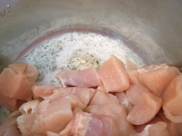 raw cubed chicken and garlic butter in an instant pot