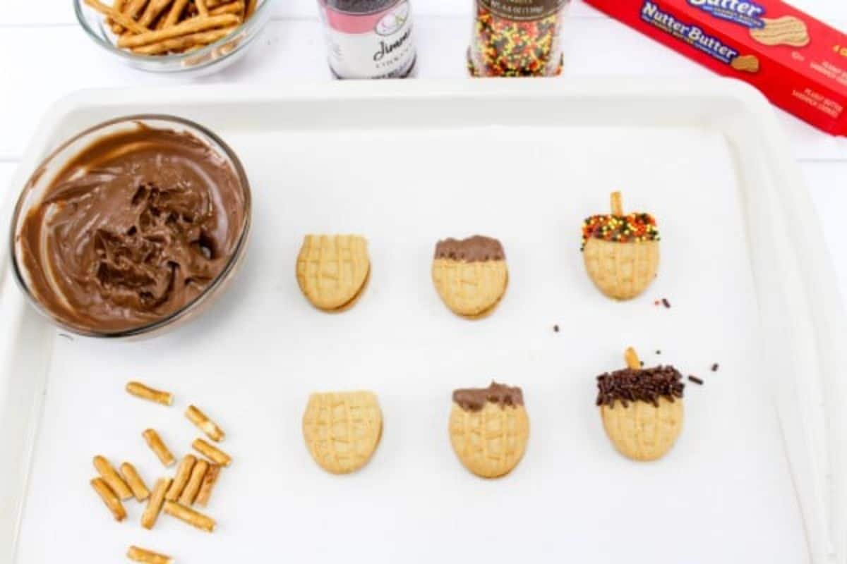 A tray with Nutter Butter cookies, pretzels, and a bowl of chocolate.