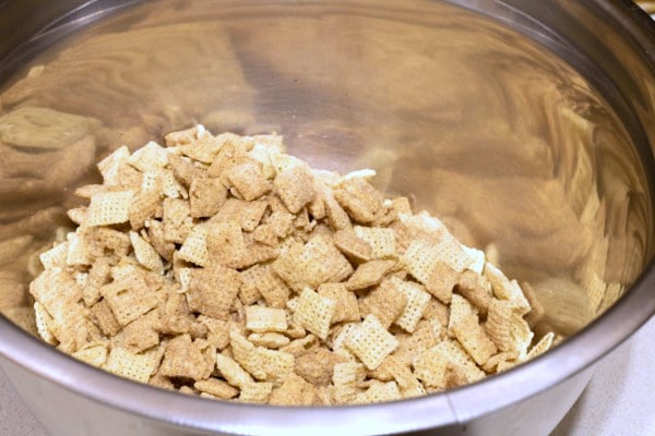 cinnamon chex mix in a metal bowl