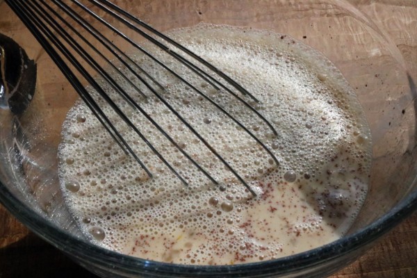 eggs, milk, vanilla, cinnamon and salt in a glass mixing bowl with a whisk in it