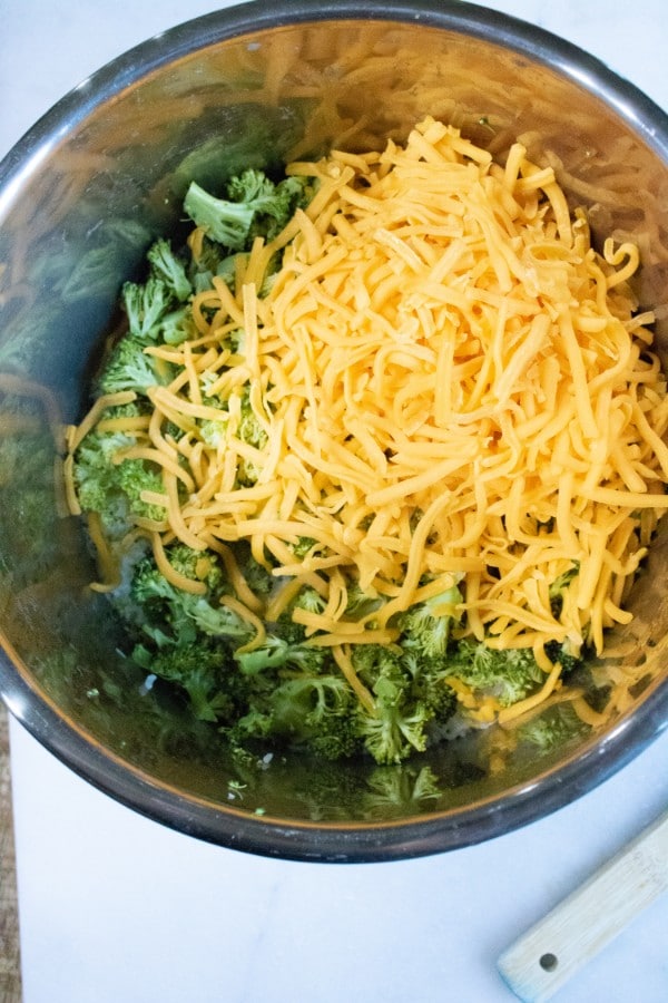 cheese, broccoli and rice in an instant pot on a white counter