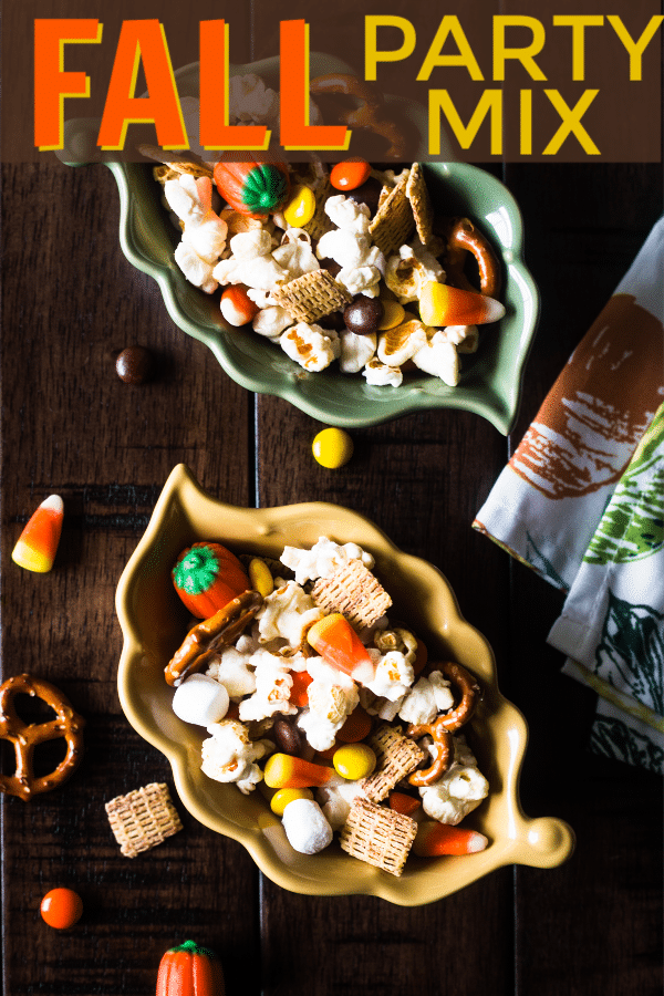 popcorn, mini marshmallows, pretzels, reeses pieces, candy corn and pumpkins, chex cereal in two leaf bowls on a table with more party mix on it with title text reading Fall Party Mix