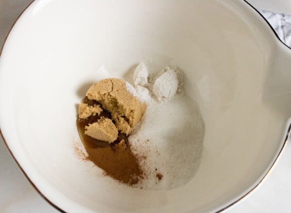 brown sugar, sugar, flour, cinnamon, and a splash of lemon juice in a large bowl