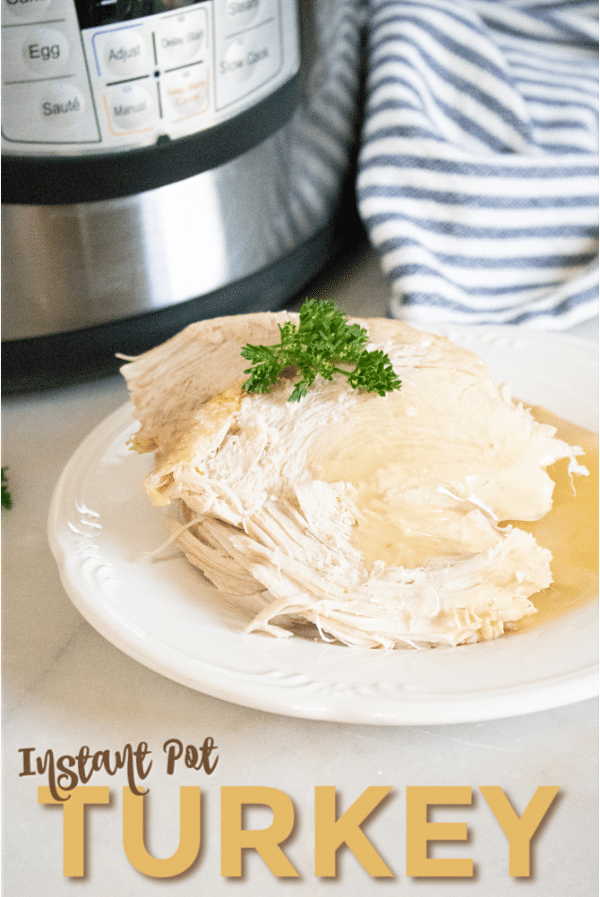 a piece of turkey topped with gravy and parsley on a white plate on a white table with an instant pot and striped linen in the background with title text reading Instant Pot Turkey