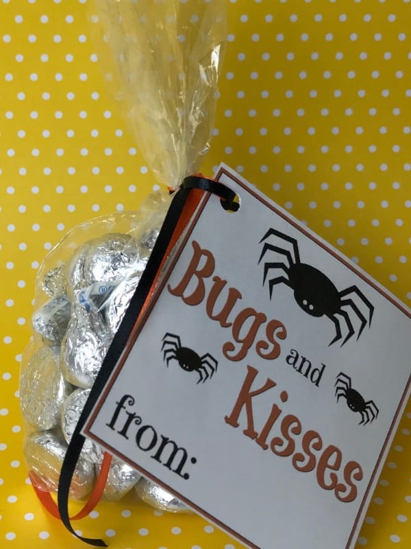 Hershey's kisses in a plastic bag with a label on it with text reading Bugs and Kisses on a yellow and white polka dot background