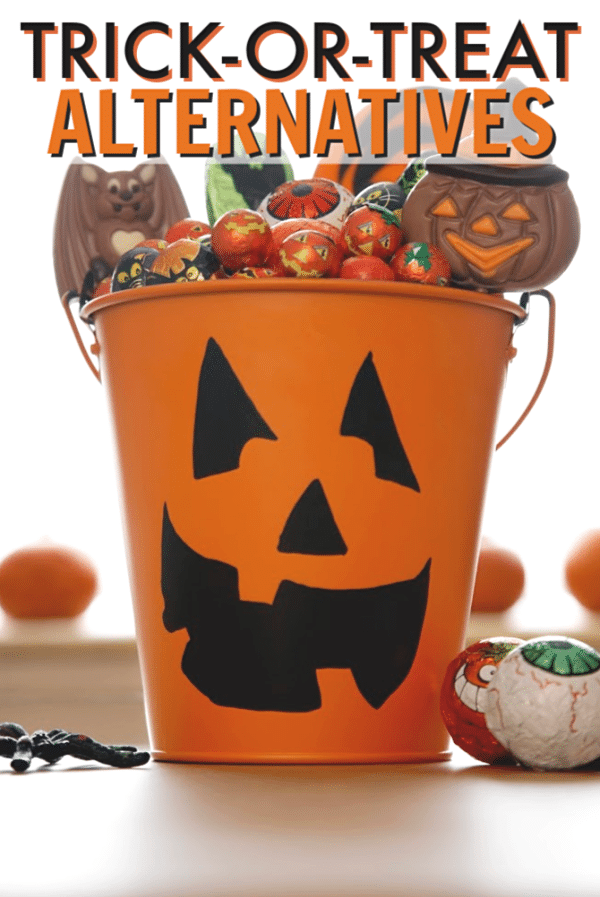 a jack-o-lantern bucket filled with candy on a table with more candy next to it with title text reading Trick-or-Treat Alternatives