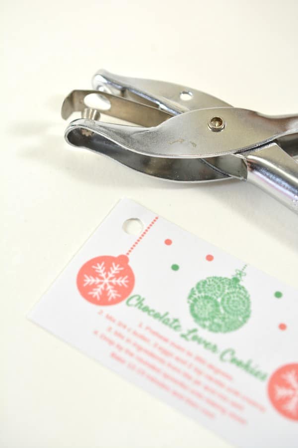 a hole punch next to a card with directions on how to make cookies