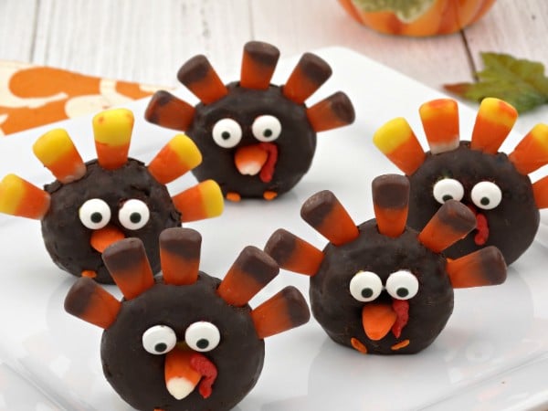 mini chocolate donuts decorated with candy corn and candy eyes to look like a turkey 