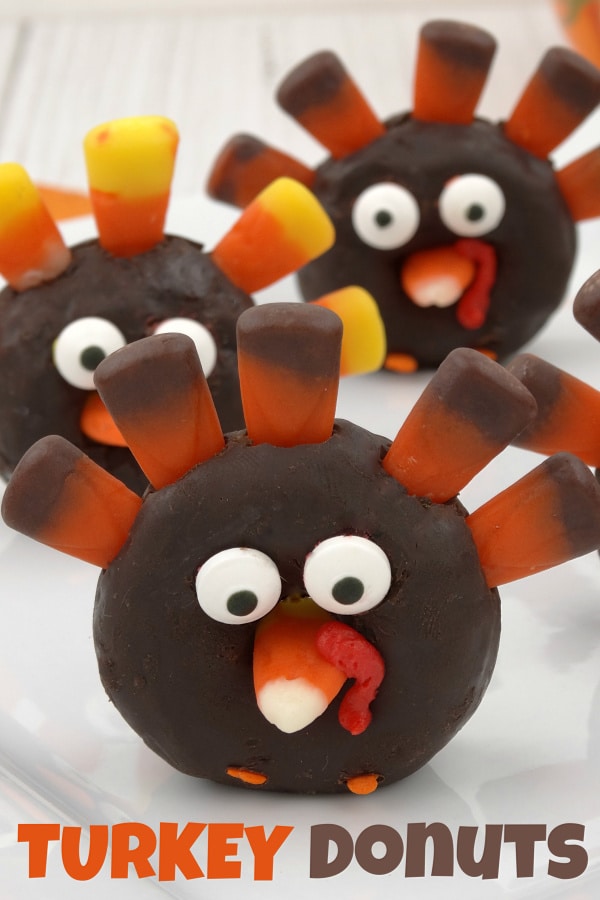mini chocolate donuts decorated with candy corn and candy eyes to look like a turkey with title text reading Turkey Donuts