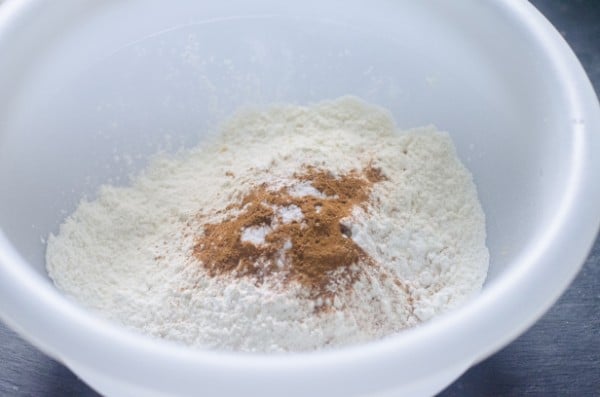 flour, cornstarch, baking powder, cinnamon, nutmeg, and salt in a white bowl
