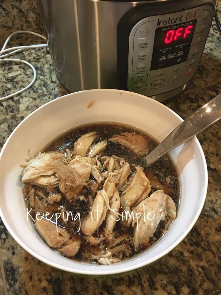 teriyaki chicken in a white bowl with a spoon in it next to an instant pot