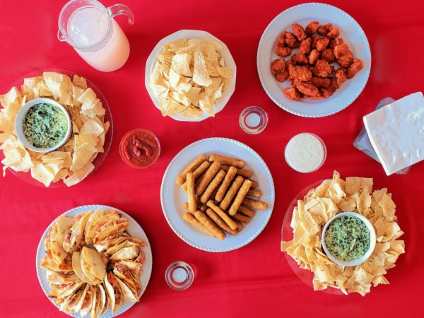 party food on plates on a red tablecloth