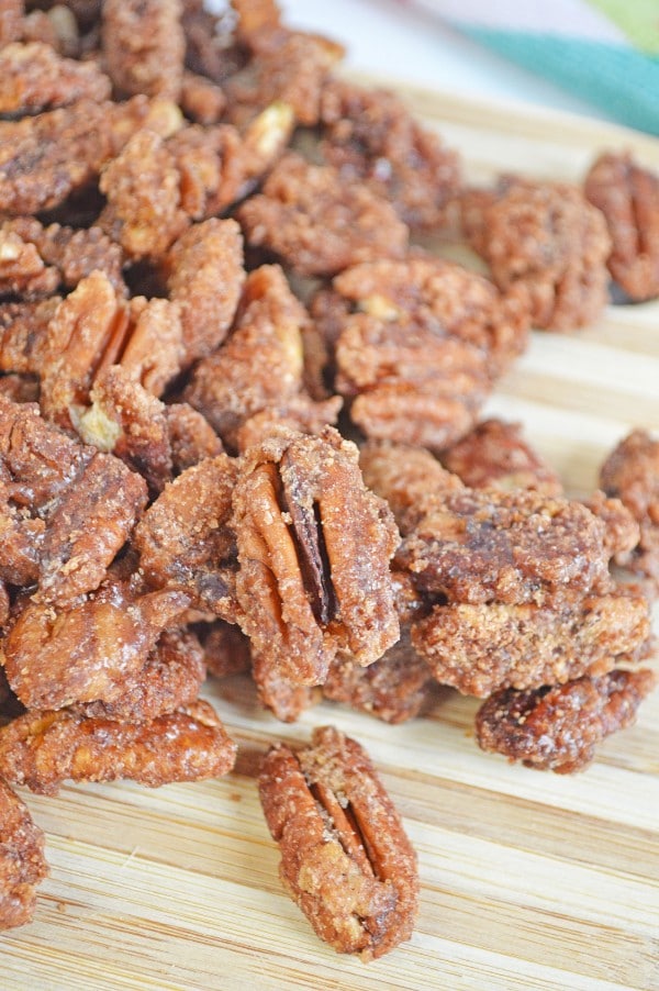 candied pecans on a wood board