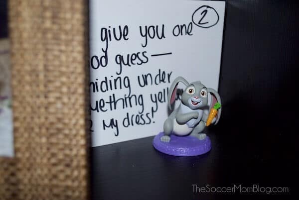 a bunny figurine with a paper behind it giving clues 