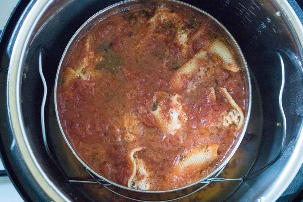 pasta shells stuffed with sausage and cheese covered in sauce in an instant pot