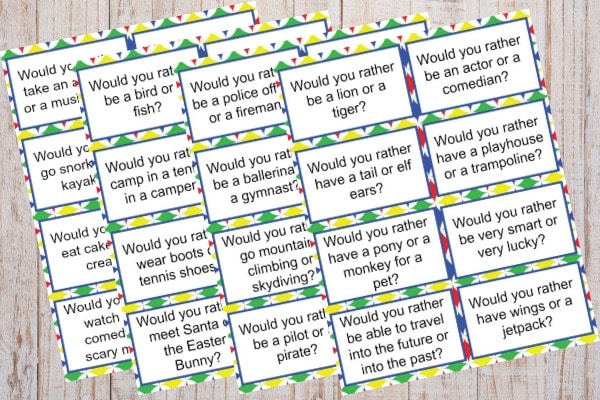 Would You Rather Questions for Kids printables on a wood background