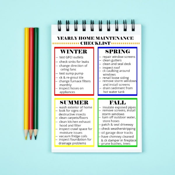 printable Yearly Home Maintenance Checklist next to colored pencils on a light green background