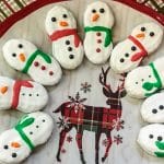 Snowman nutter butter cookies arranged on a plate