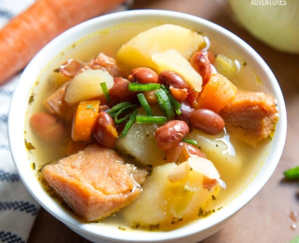 ham and bean potato soup in a bowl with a carrot in the background