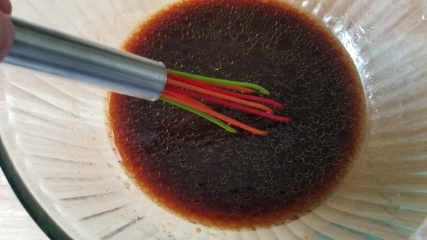 sauce in a bowl with a whisk in it