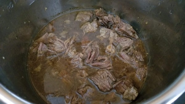 shredded beef and liquid in an instant pot