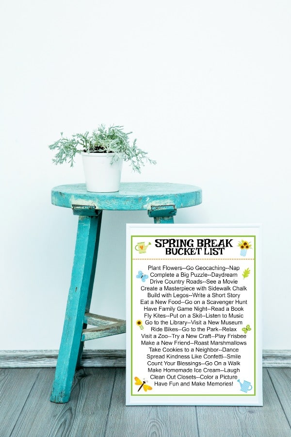 printable Spring Break Bucket List for families leaning against a blue stool with a plant on it