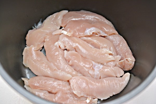 raw chicken cut in strips in an instant pot