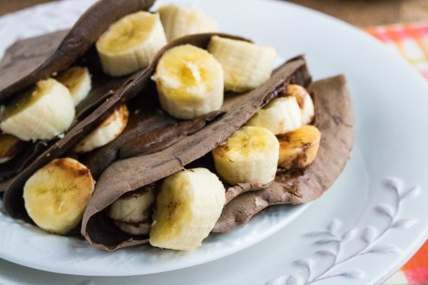 Chocolate Nutella and Banana Crepes on a white plate