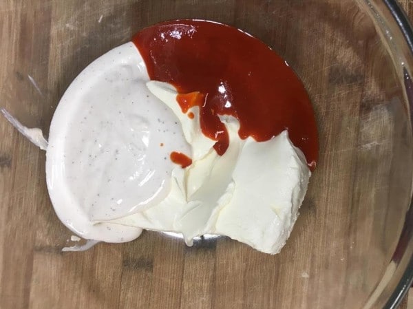 cream cheese, ranch and buffalo sauce in a glass bowl