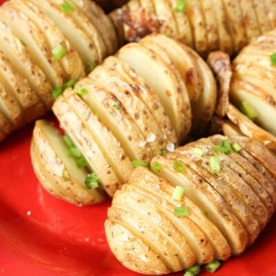Hasselback Potatoes on red plate
