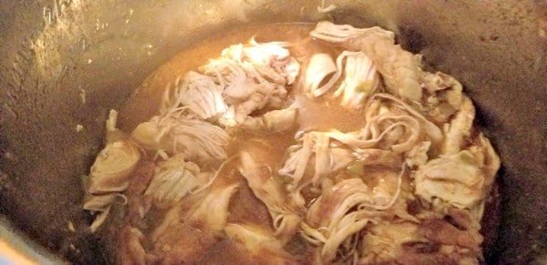 shredded chicken and liquid in an instant pot
