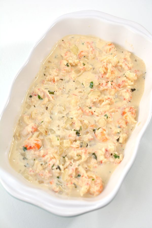 unbaked keto lobster casserole in a white dish on a white background