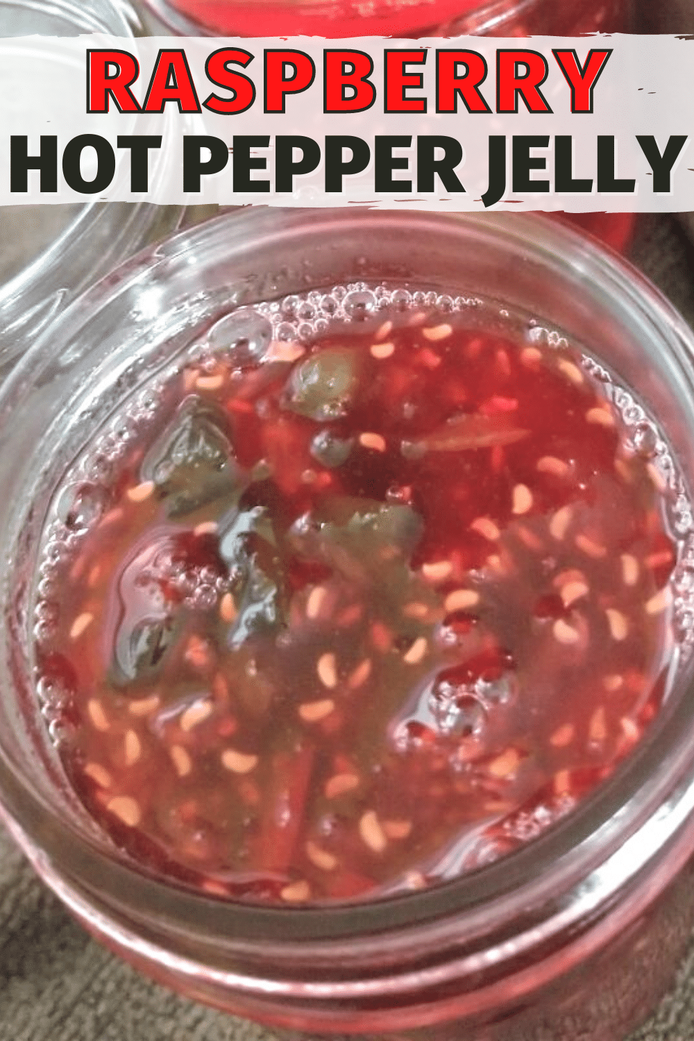 This raspberry hot pepper jelly recipe is so easy to make a great way to use up peppers from the garden. Jalapeno jelly can be used in so many ways. #jelly #peppers #jalapenos via @wondermomwannab