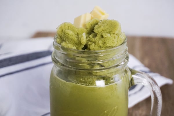 machta green tea frappuccino in a glass jar mug on a wood background with farmhouse ticking linen