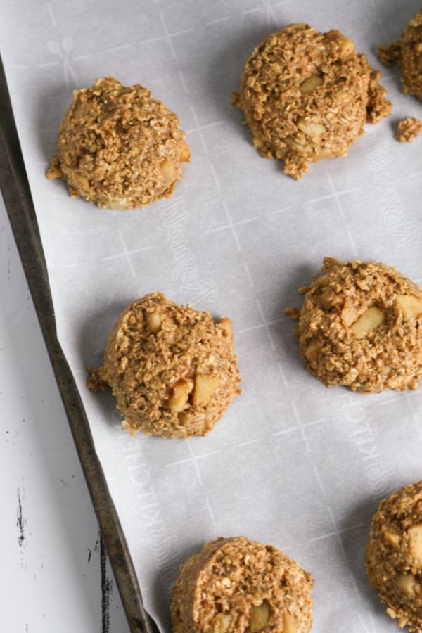 apple pumpkin breakfast cookies dough in mounds on a cookie sheet lined with parchment paper