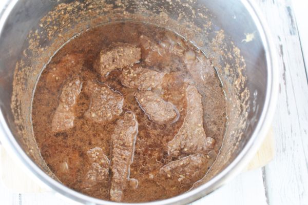 an instant pot filled with beef and sauce