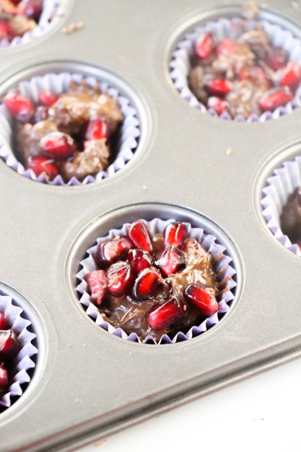 pomegranate chocolate candy cups in a muffin tin