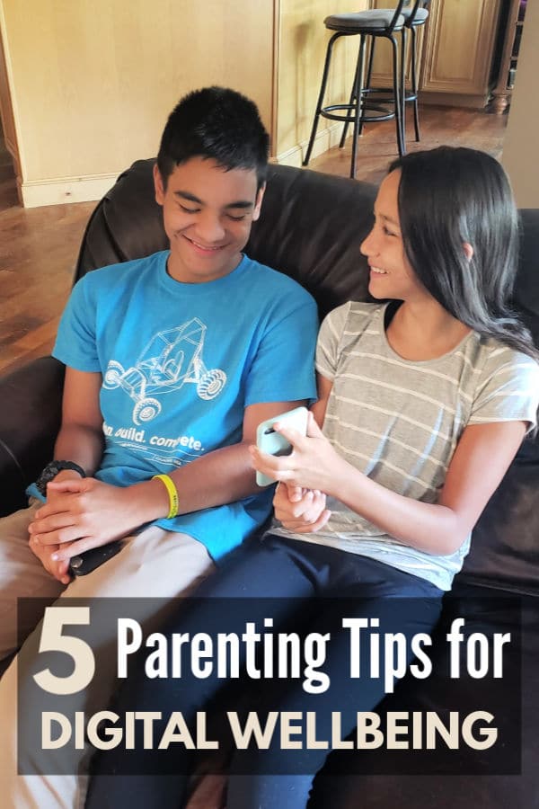 a boy and girl sitting on a couch looking at a phone with title text reading 5 Parenting Tips for Digital Wellbeing