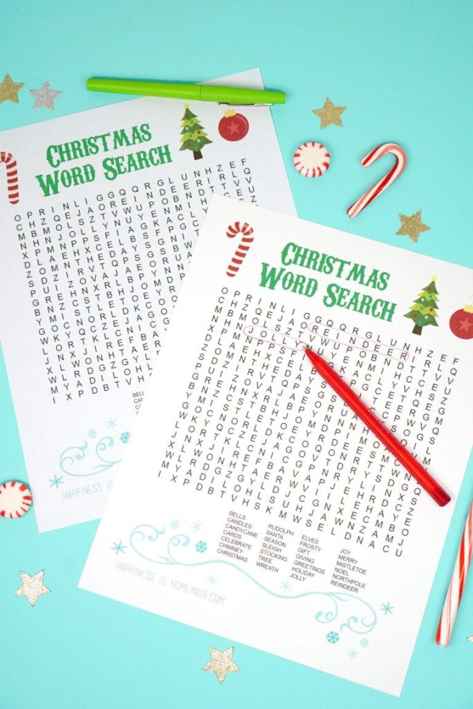printable Christmas word search on a blue background with pens and candy canes on it