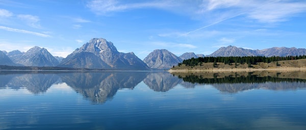a lake with mountains in the background