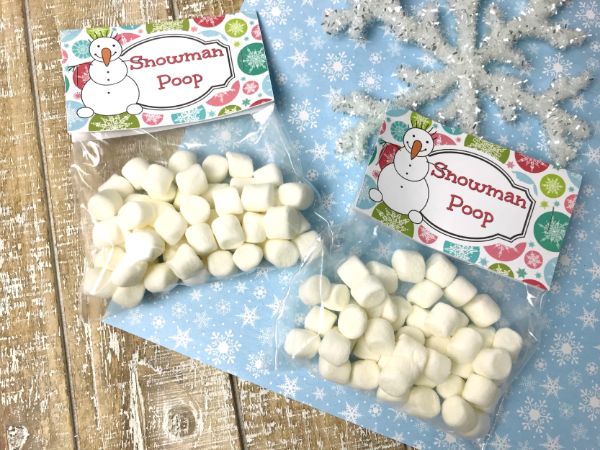 marshmallows in plastic bags labelled Snowman Poop on a brown and blue linen next to a snowflake