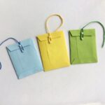 blue, yellow, green miniature envelopes with string closing the envelopes