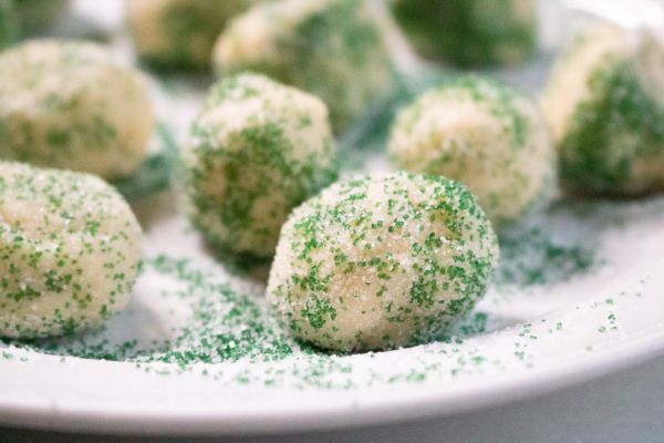 peppermint snickerdoodles rolled in green sprinkles on a white plate