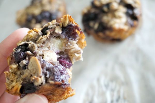 blueberry almond baked oatmeal cups with a bite taken out of one