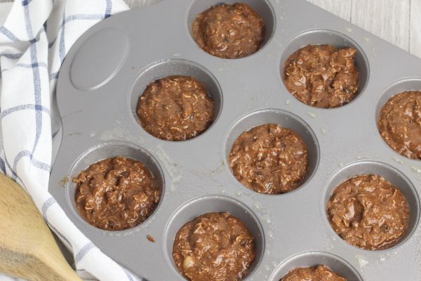 muffin pan with batter for Chocolate Banana Oat Chocolate Chip Muffins in it
