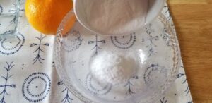 adding baking soda to a glass bowl