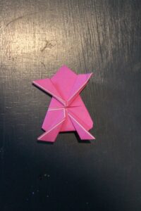 instructions for making origami jumping frogs with pink paper