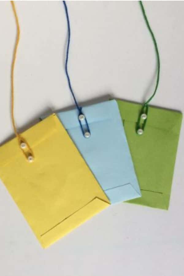yellow, blue and green mini envelopes on a white background